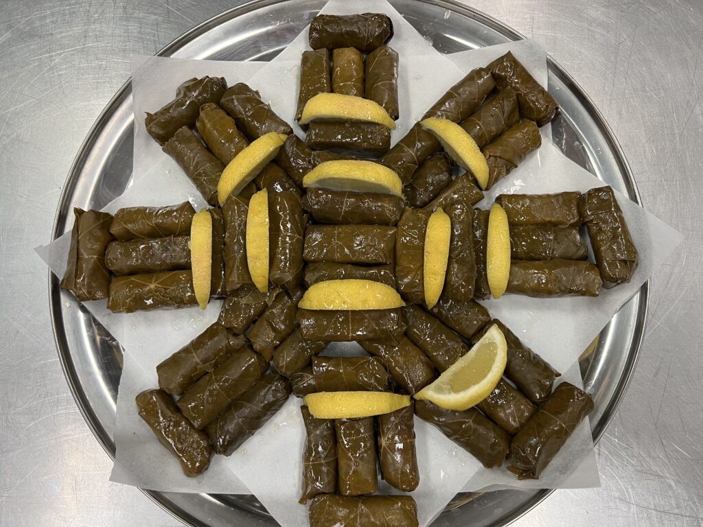 Stuffed Grape leaves on a plate with lemons